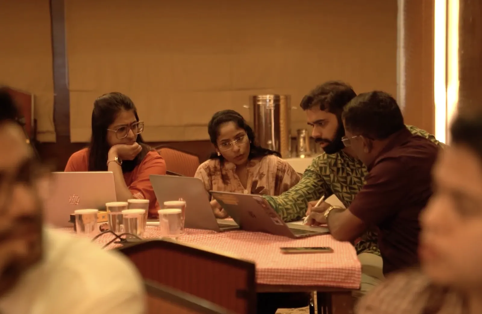 Cohort members working together around a table